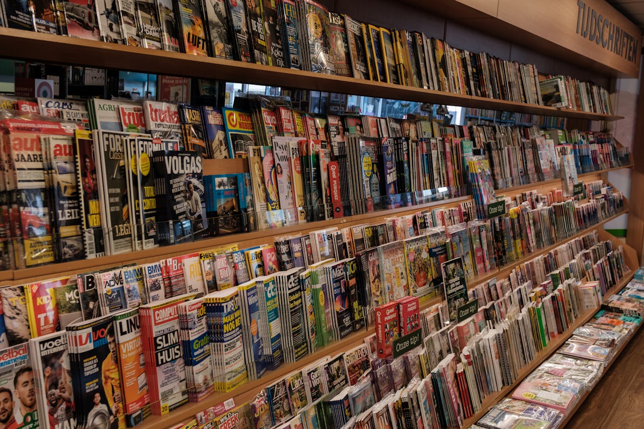 Colorful array of magazines in a bookstore in Amsterdam, showcasing a variety of topics.